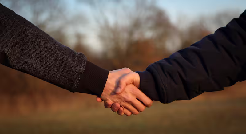 Background image with two hands shaking